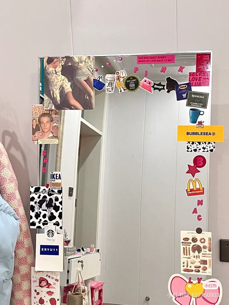 there is a mirror with many stickers on it and a bag next to it