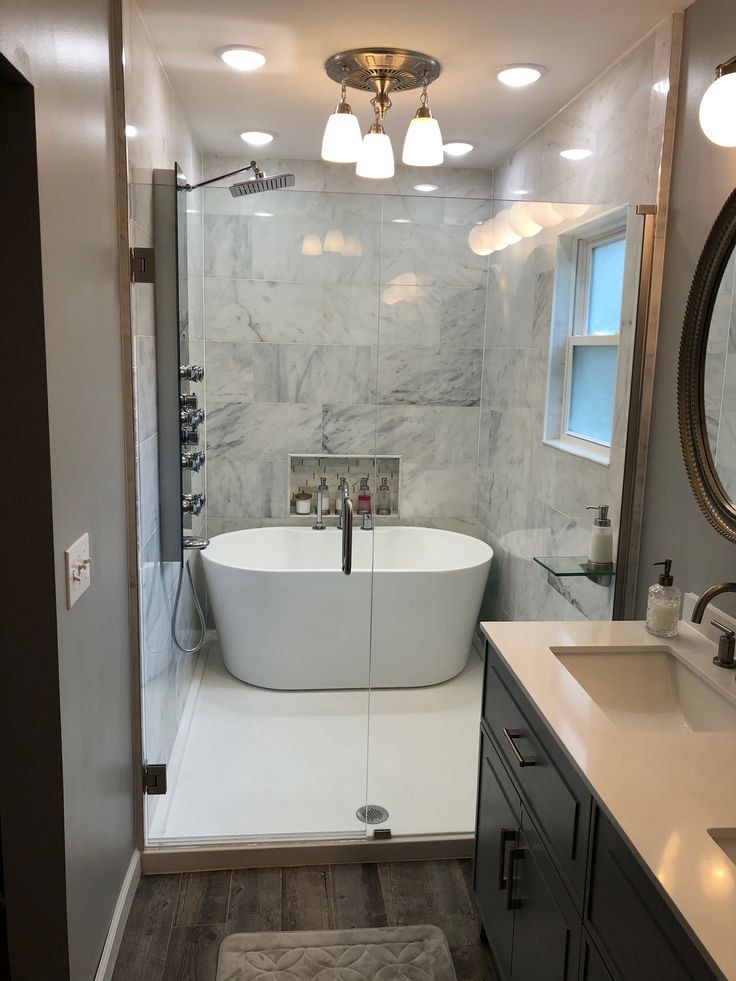 a white bath tub sitting inside of a bathroom