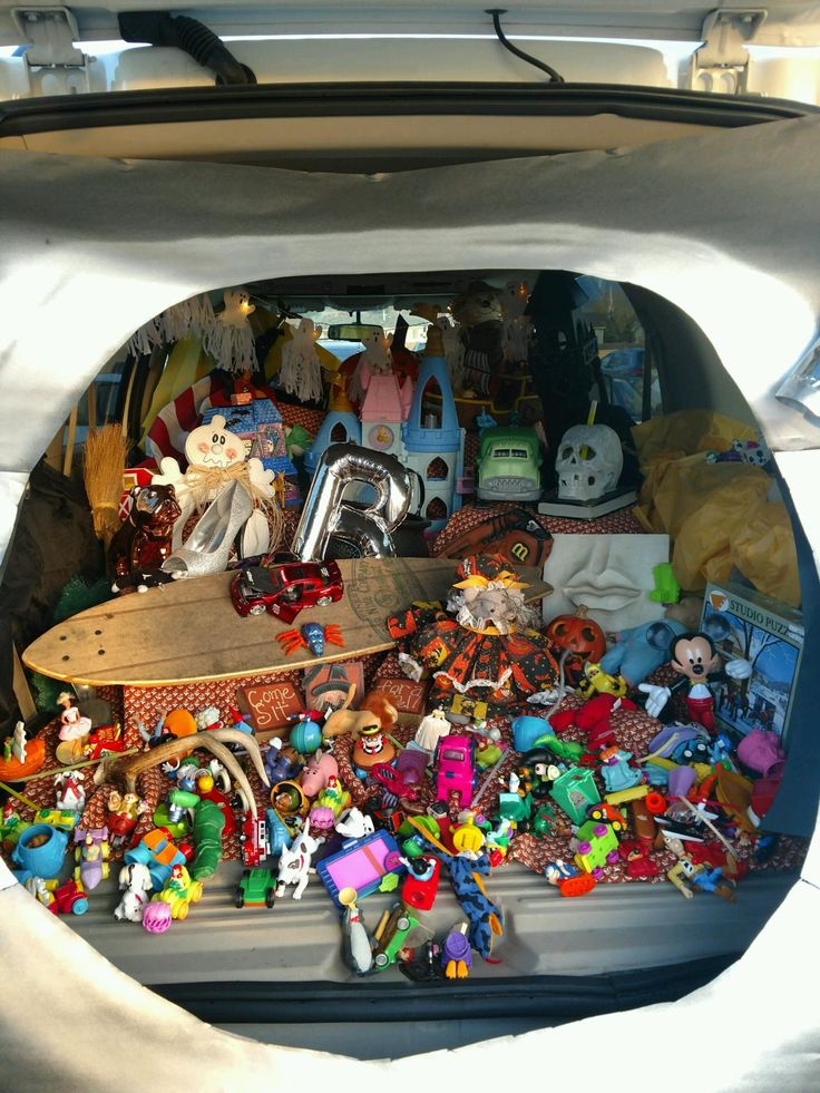 the trunk of a car filled with toys