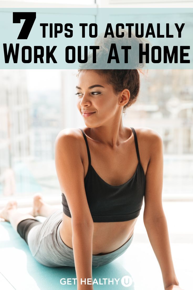 a woman doing yoga on the floor with text overlay that reads 7 tips to actually work out at home