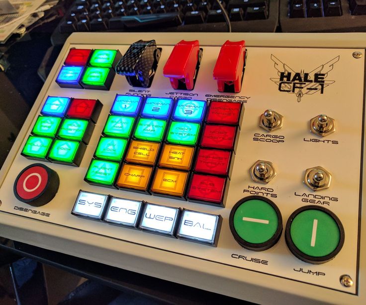 an electronic device with buttons and knobs on top of a table next to a keyboard