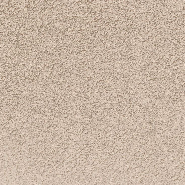 a beige stucco wall textured with white paint