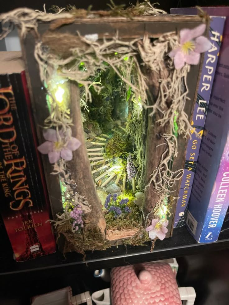 a book shelf with some books on it and a small statue in the middle of it