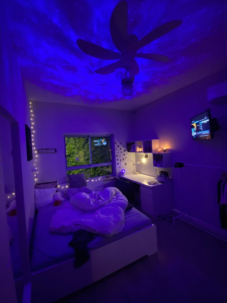 a bedroom with purple lighting and a ceiling fan