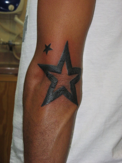 a man with a star tattoo on his arm