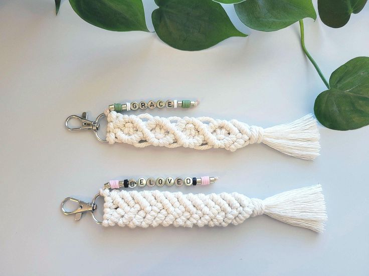 two crocheted key chains sitting next to each other on top of a table