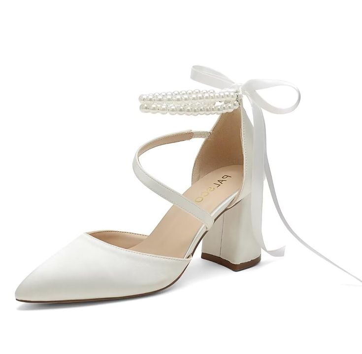 a pair of white shoes with pearls on the heel