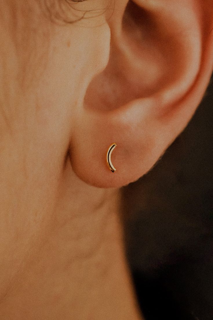 These cute Tiny Arc Stud earrings are perfect accent earrings. Each stud is comfortable and perfect for everyday wear. Measuring approximately 5mm. Crafted in Solid 14k Gold or Rose Gold for the stunning, minimal earring!Choose a SINGLE EARRING or a PAIR. These studs have a classic ear nut backing. Every piece is organic and unique — no two Hannah Naomi pieces are exactly alike.Hand-crafted to order in our Portland, OR studio. Unique Small Earrings, Flat Back Earrings Silver, Accent Earrings, Lobe Piercings, Flat Back Earrings, Minimal Earrings, Lobe Piercing, Stud Style, 2024 Christmas