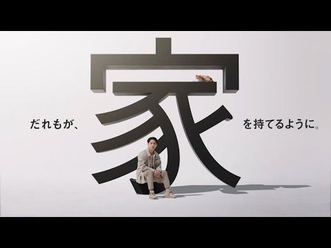 a man sitting on top of a chair in front of a wall with chinese writing