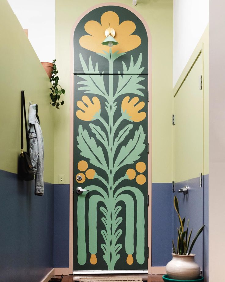 the door is decorated with flowers and leaves in green, blue, and yellow colors