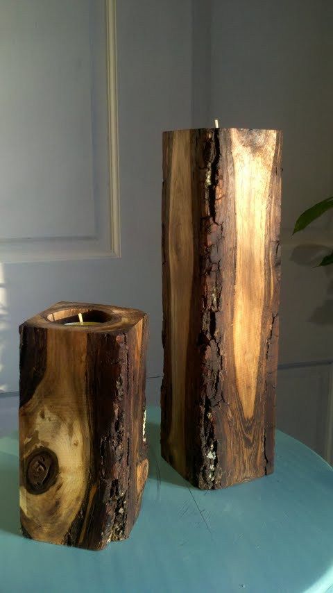 two pieces of wood sitting on top of a blue tablecloth covered table next to a potted plant