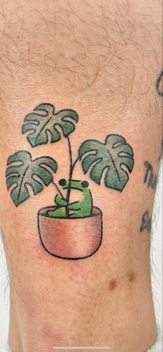 a man's back with a green plant on it