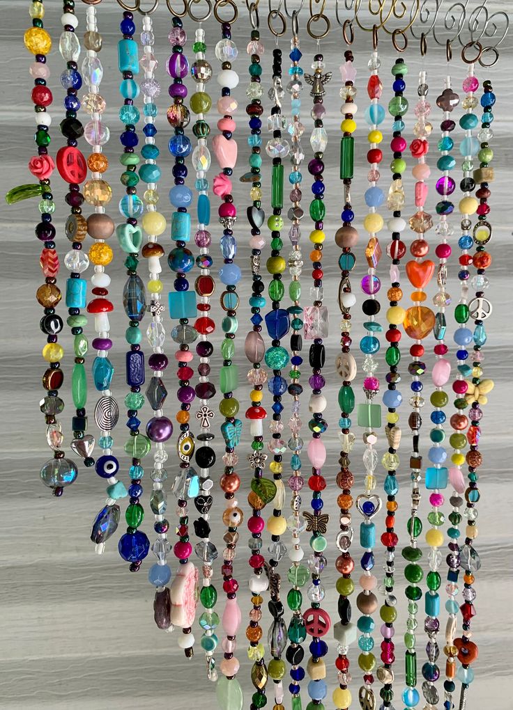 a bunch of beads hanging from the side of a wall