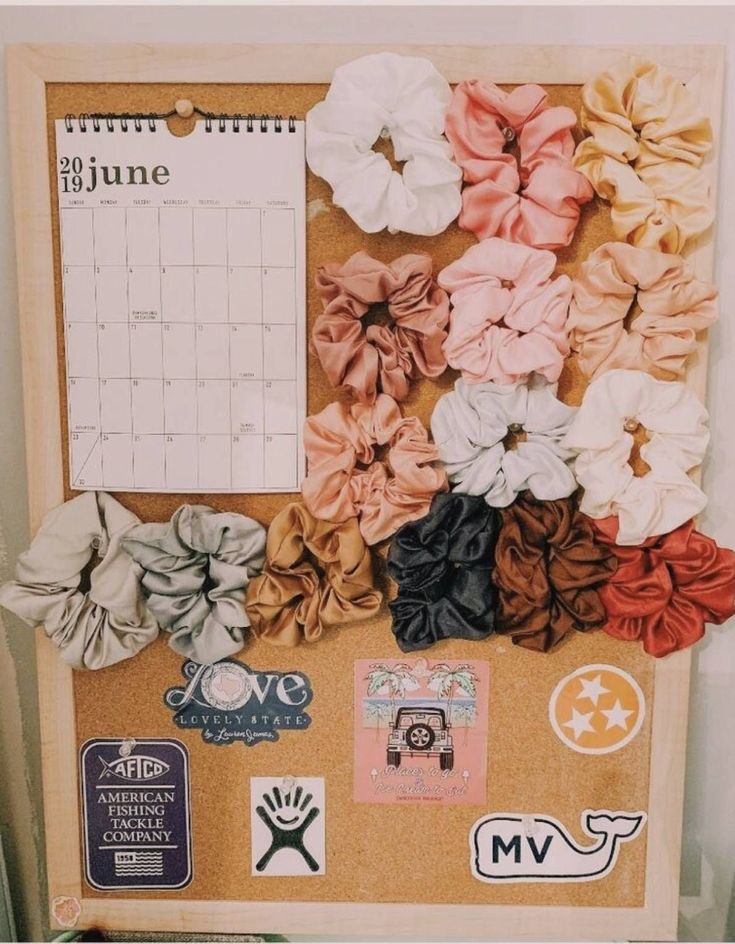 a bulletin board covered in different types of scrunffles and pins with a red arrow pointing to the right