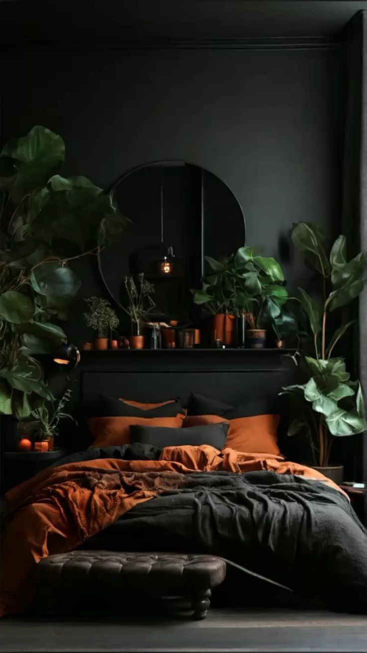 a bedroom with black walls and lots of greenery in the corner, including potted plants