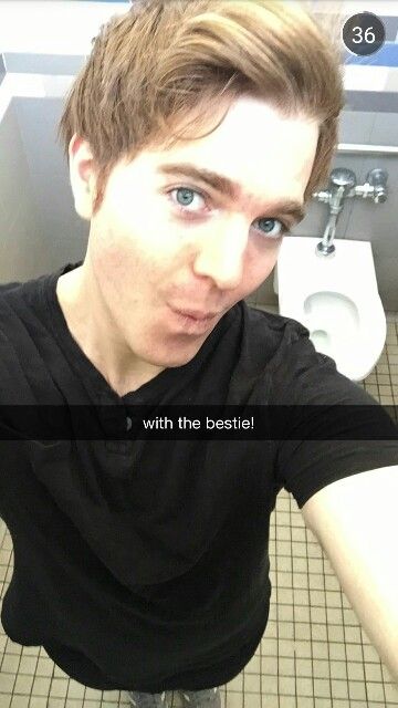 a young man is taking a selfie in the bathroom with his hands on his hips