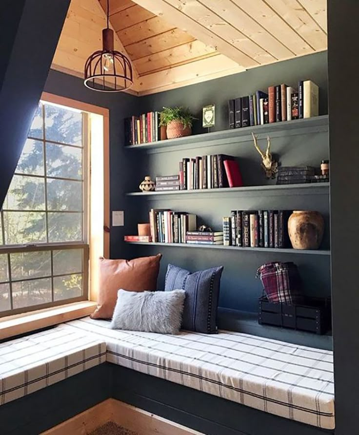 a window seat with bookshelves in the corner