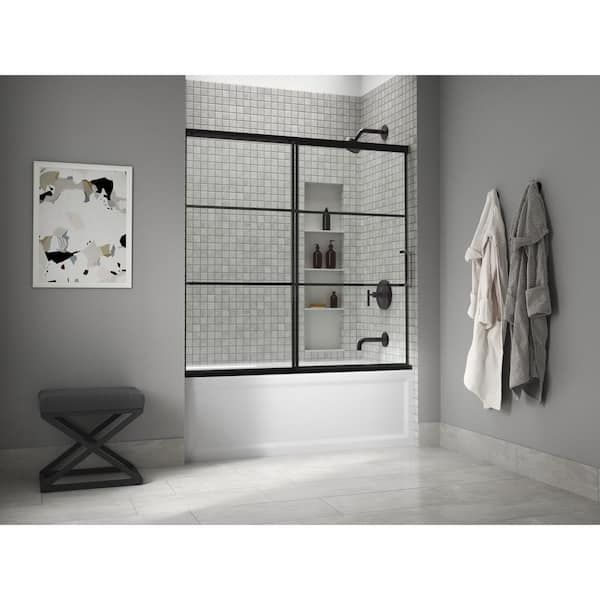 a bath room with a toilet and a walk in shower next to a wall mounted towel rack