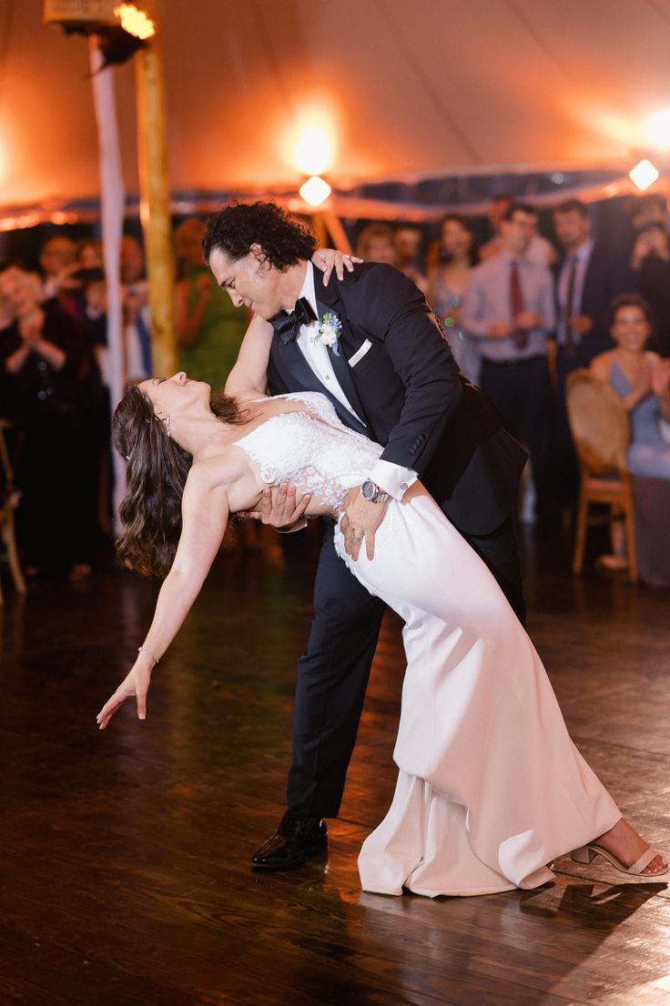 a bride and groom are dancing on the dance floor