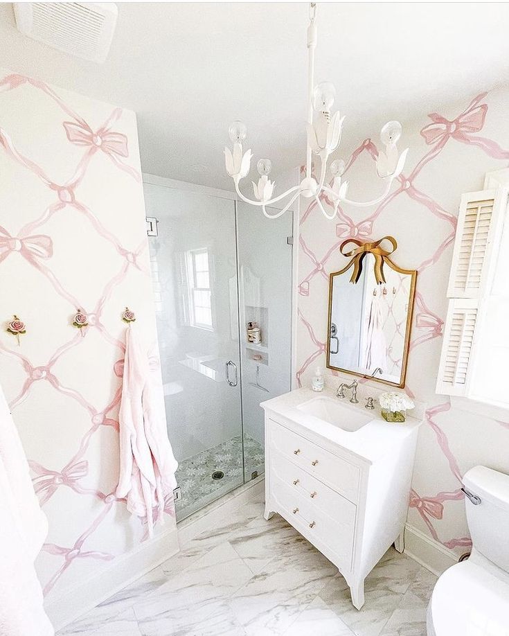 the bathroom is decorated in pink and white