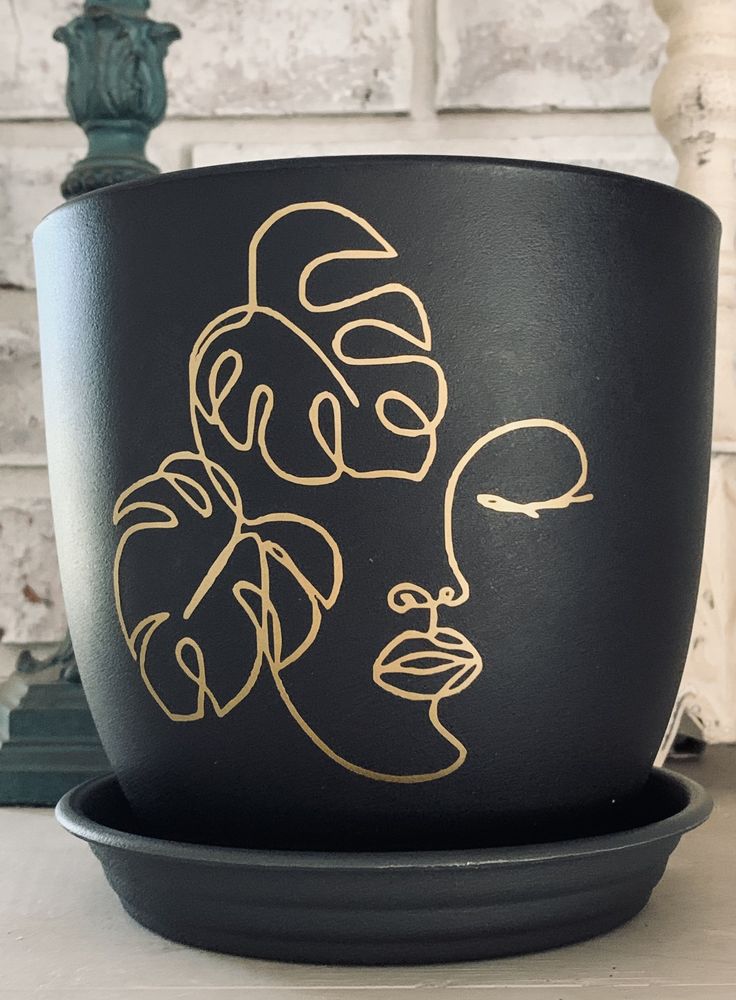 a black pot with gold designs on it