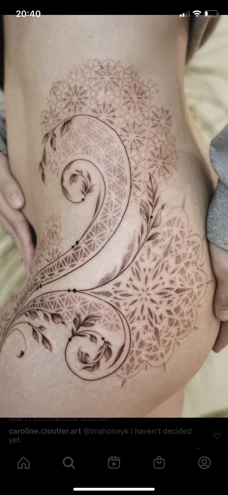 a woman's stomach with an intricate design on the side and bottom part of her belly