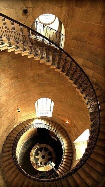 a spiral staircase in an old brick building