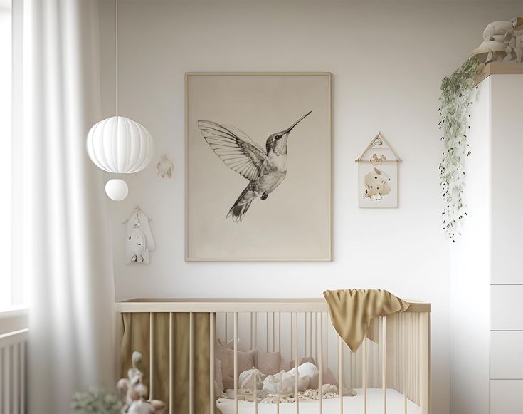 a baby's room with a hummingbird painting on the wall