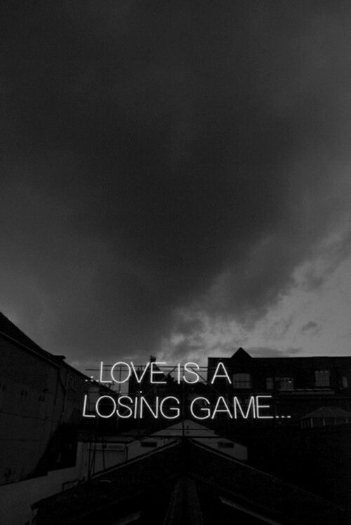 the words love is a losing game against a dark sky