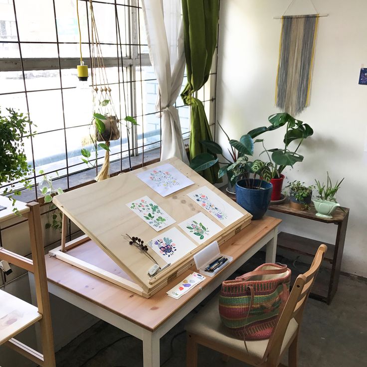 a table with some plants and pictures on it