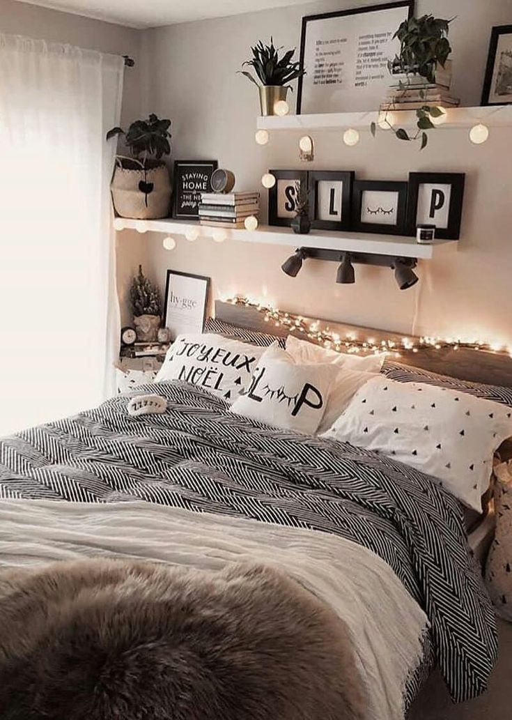 a bedroom decorated with lights and pictures on the wall above the bed, along with other decorations