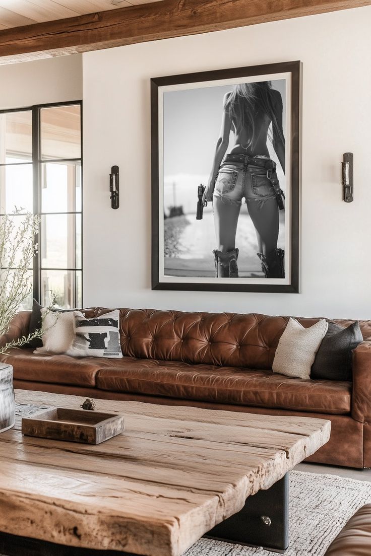 a living room with leather couches and a coffee table in front of a window