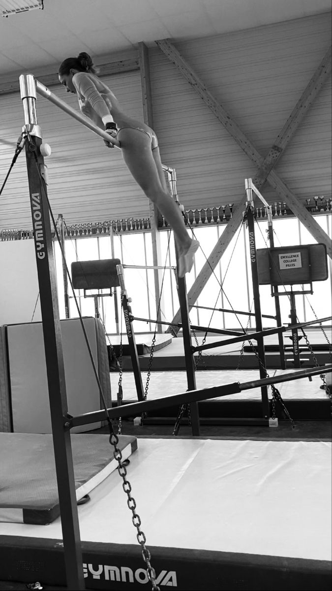 a woman is standing on top of a trampoline in black and white photo