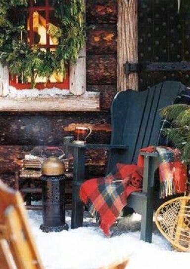 a rocking chair sitting in the snow next to a christmas tree and other holiday decorations