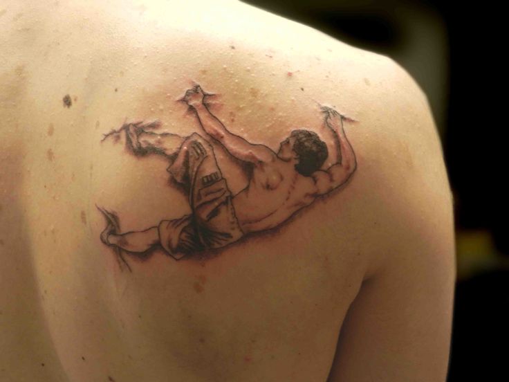 a man with a tattoo on his back