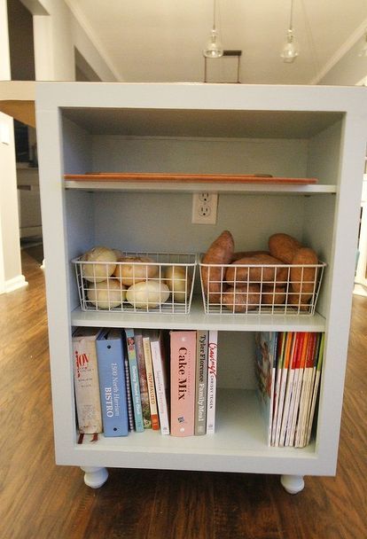 a book shelf with books and baskets on it