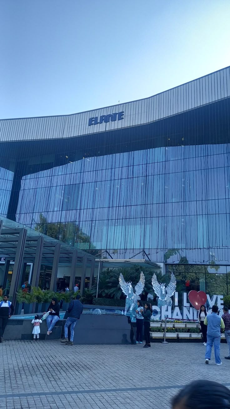 people are standing in front of a large building with glass windows and the words live shanton on it