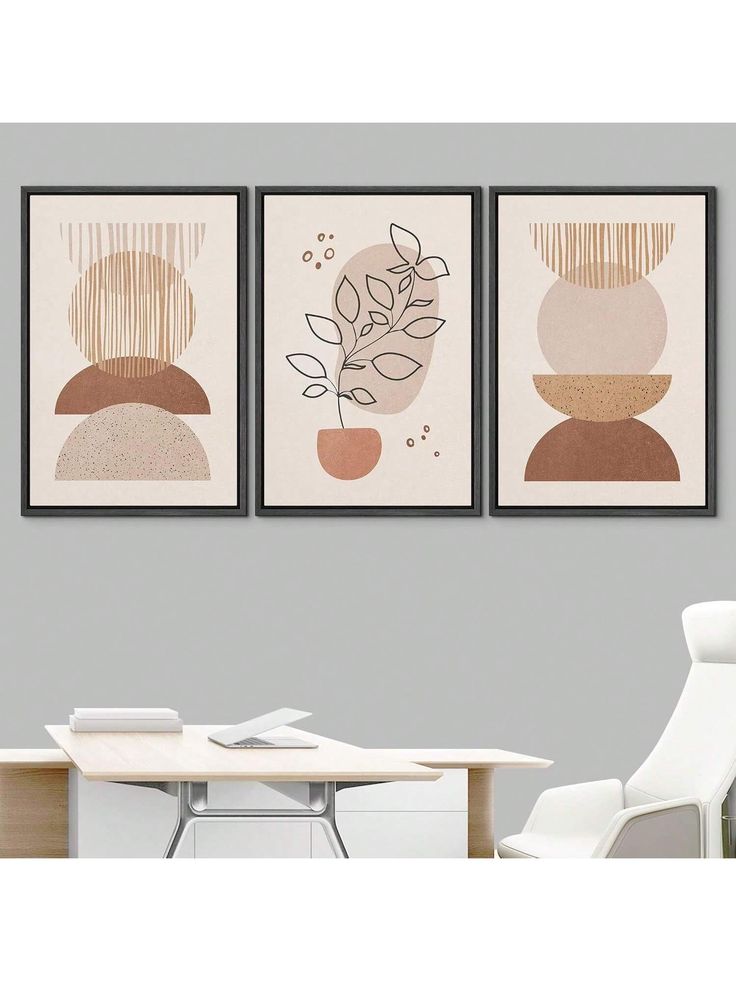 three paintings hanging on the wall above a table