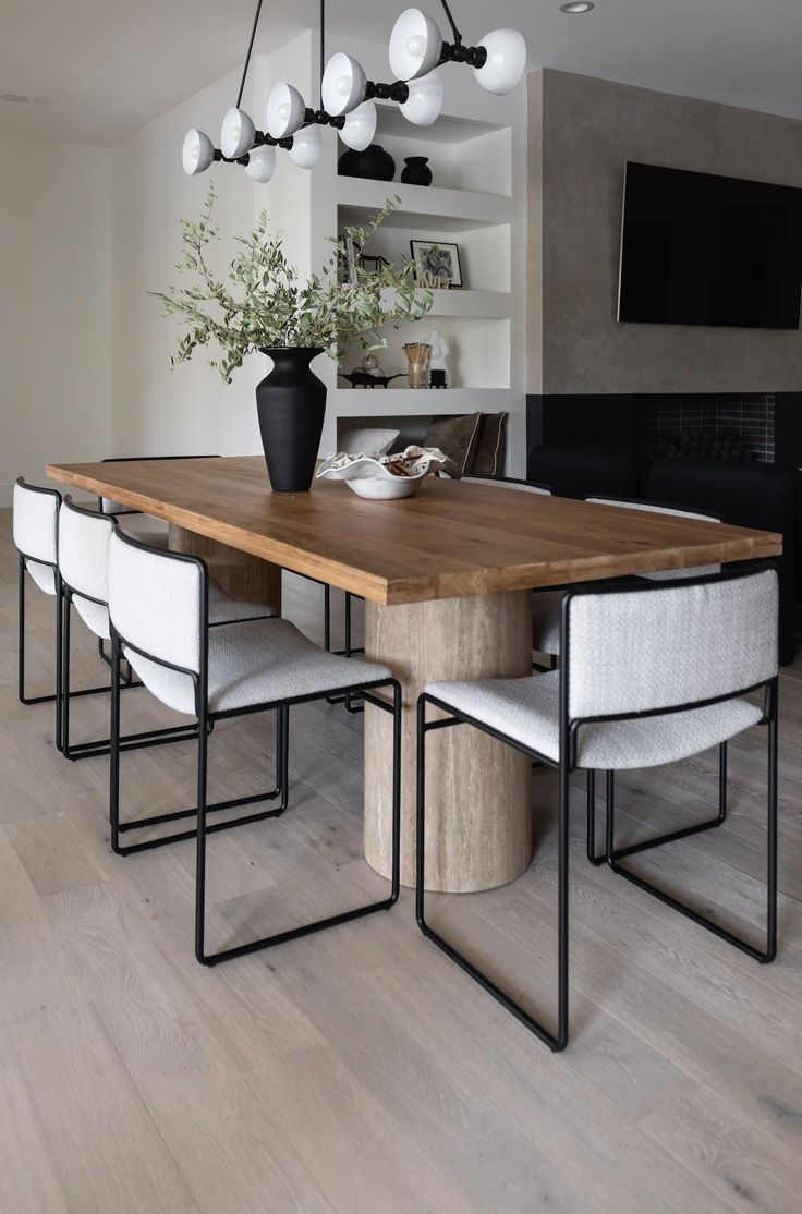 a dining room table with white chairs around it