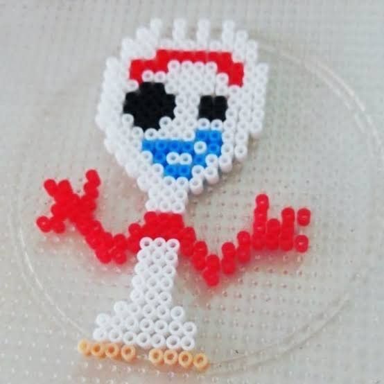 the bead art is made to look like an image of a cartoon character on a plate