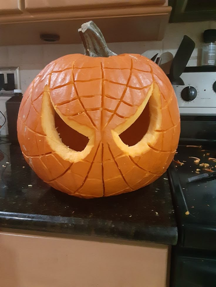 a carved pumpkin sitting on top of a kitchen counter