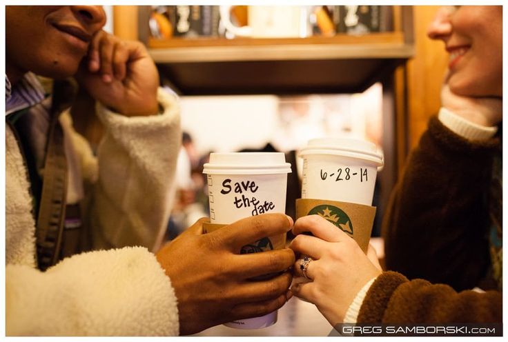 two people are holding cups with coffee on them