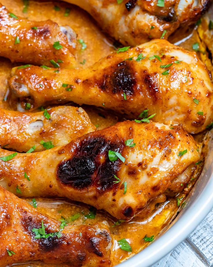 baked chicken wings with orange sauce and parsley in a pan, ready to be eaten