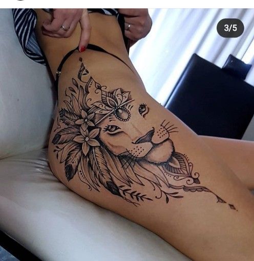 a woman with a tattoo on her stomach is sitting in a chair and touching the side of her thigh