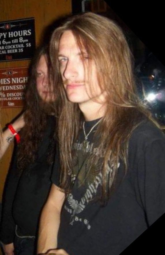 two people standing next to each other with long hair