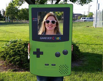 a woman holding up a video game controller costume for the cameraman in front of her