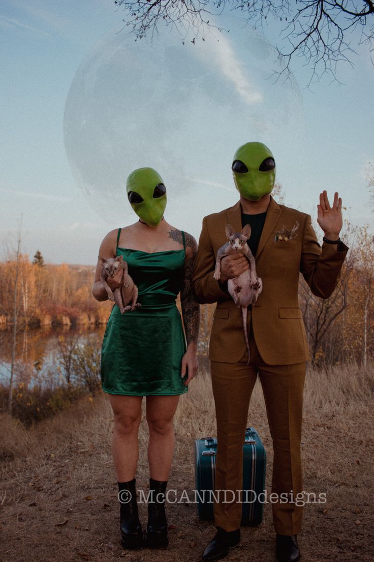 two people in alien costumes standing next to each other