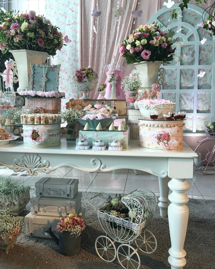 a table topped with lots of cakes and cupcakes