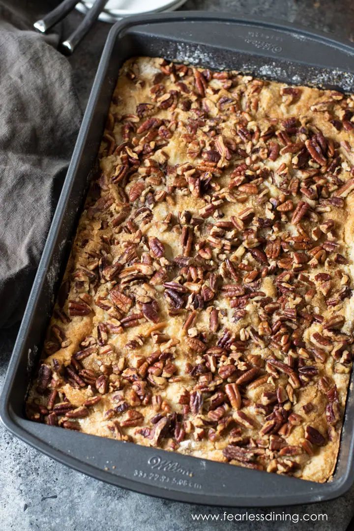 a casserole dish with pecans on top