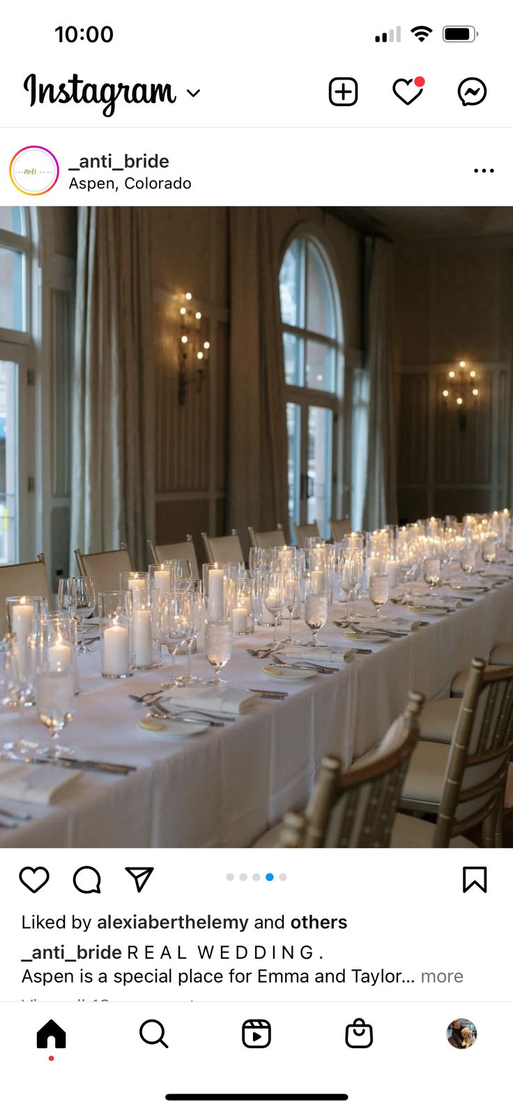 a long table is set up with candles and place settings for an elegant wedding reception